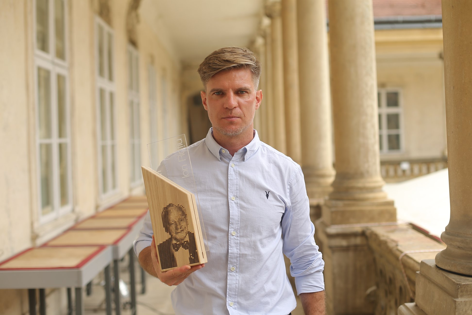 Paul Radu holds the Ion Raţiu Journalism Award, which he won in 2018 for The RISE Project investigative series into the underground businesses of Romanians suspected of breaking the law in Romania and Brazil. (Photo courtesy Paul Radu)