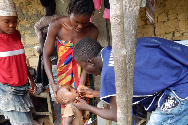 A young girl gets vitamin A supplement during a measles and polio vaccination drive. (Photo/CDC)