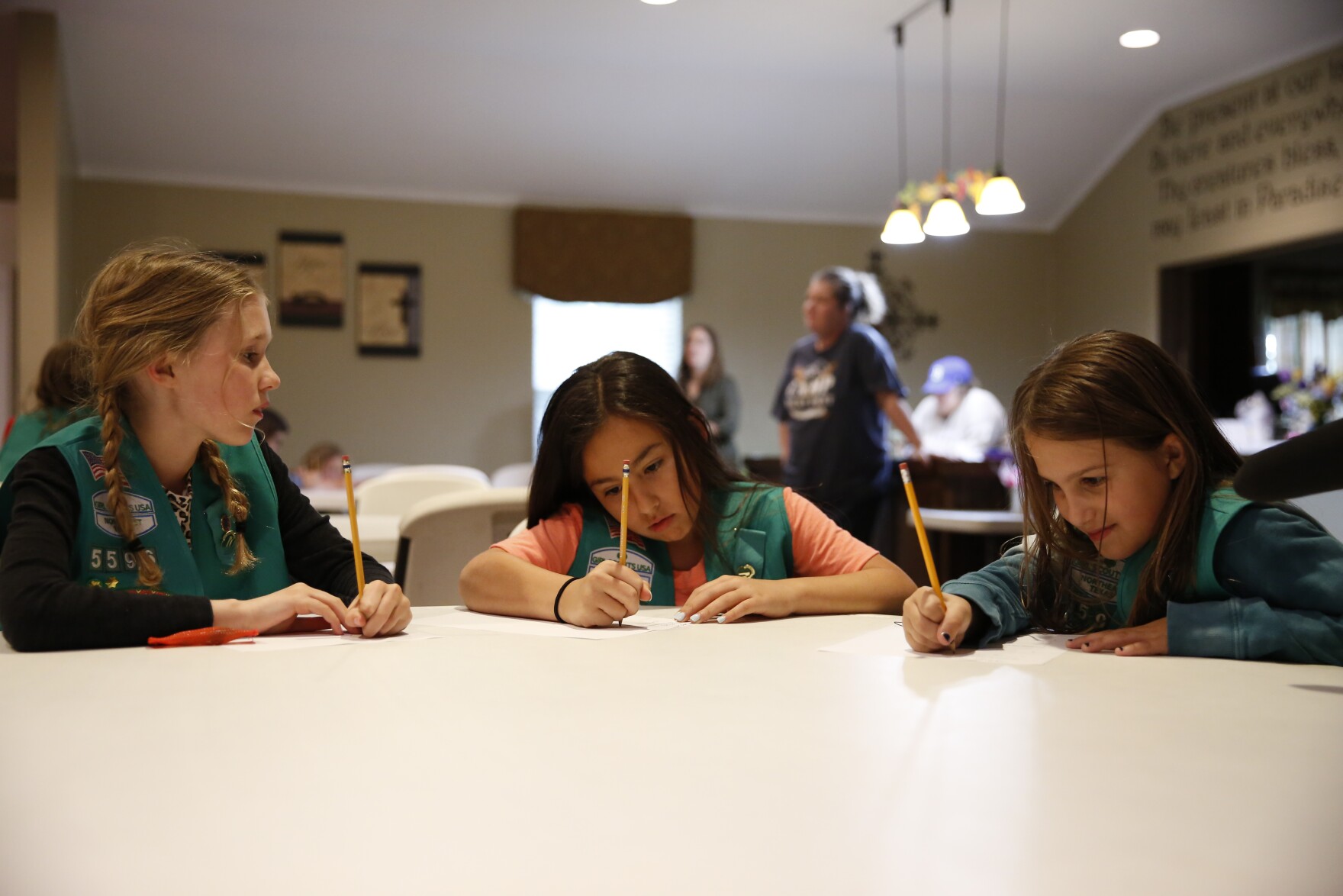McKinley Reid, Audrianna Guerrero and Sydney Judge are all part of Girl Scout Troop 5596. They started working on activities for their Okay to Say mental health badge in April. "We were learning about stress and empathy and gratitude," Judge explained. ©Trevon McWilliams/KERA
