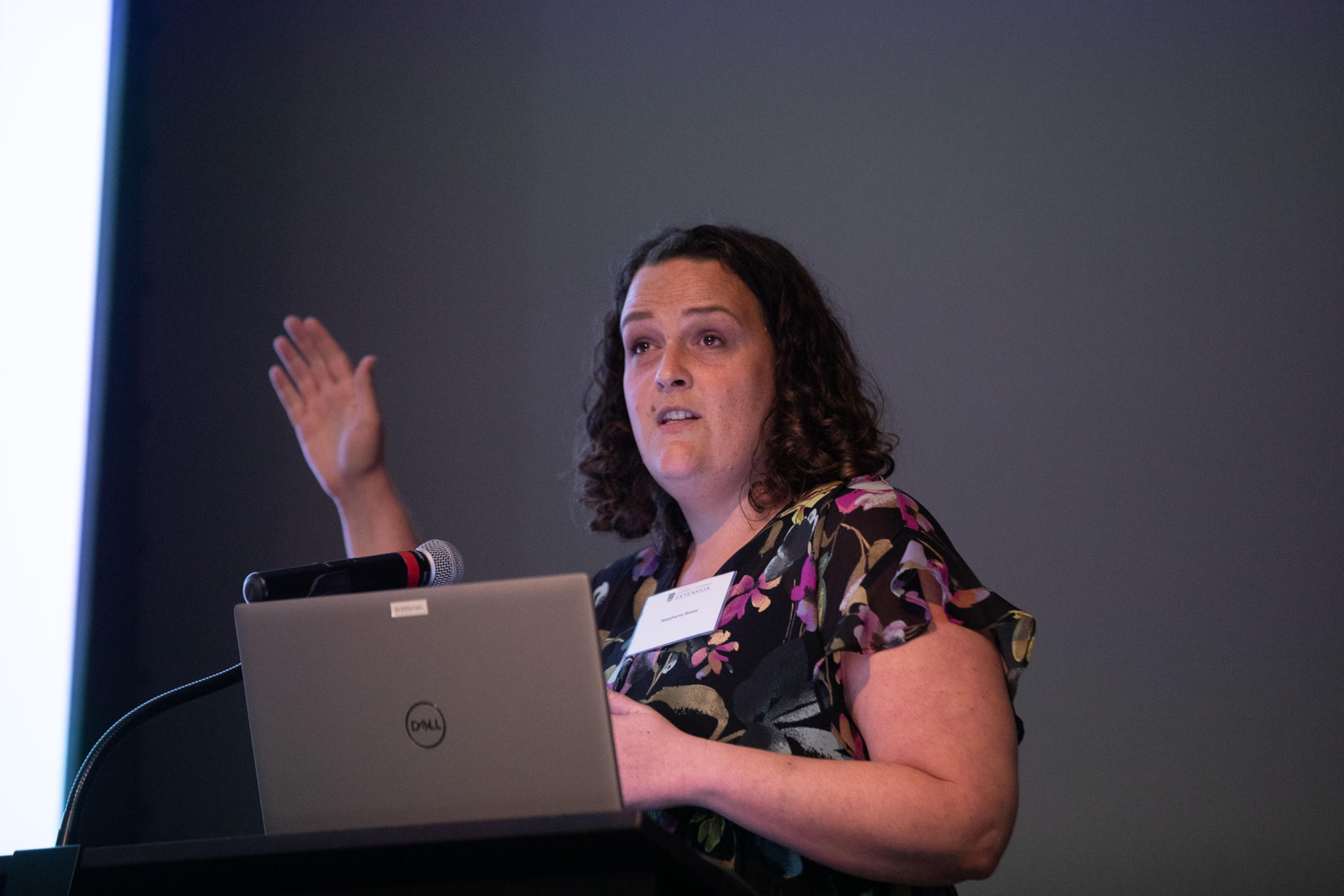 ©Riley Bunch/GPB News: Stephanie Basey, a doctoral student at Mercer University School of Medicine, presents findings on the mental health of Georgia's farmers at a summit in Tifton on May 18. Industry experts seek to get resources to farmers, who don't always know where to turn for help. 