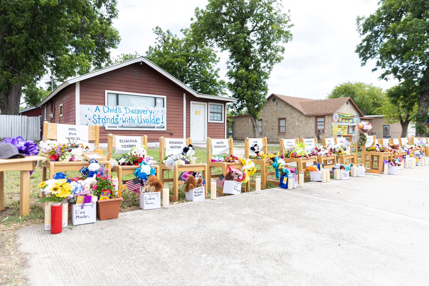 ©Sipa USA/Joshua Guerra/Sipa USA via Reuters.: Twenty one chairs, flags and crosses are displayed in front of local businesses on May 30, 2022, in Uvalde. They each honor the 19 students and two teachers killed in a mass shooting at Robb Elementary School in Uvalde.