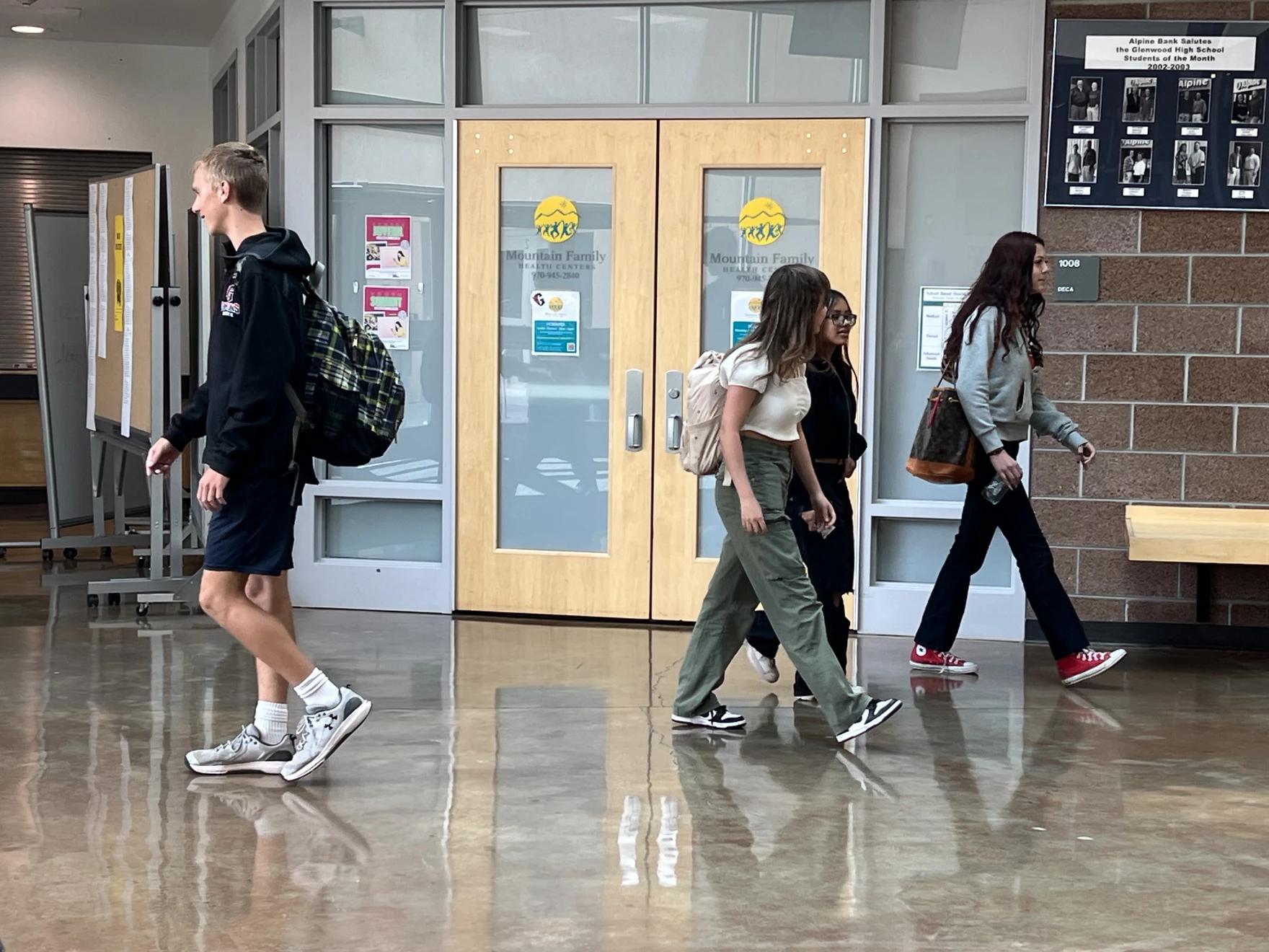 ©Leigh Paterson/KUNC: Students walk past the doors of the school-based health center at Glenwood Springs High School during a passing period on September 19th, 2023. Every student who goes in for a medical or behavioral health appointment is screened for depression, anxiety and self-harm.