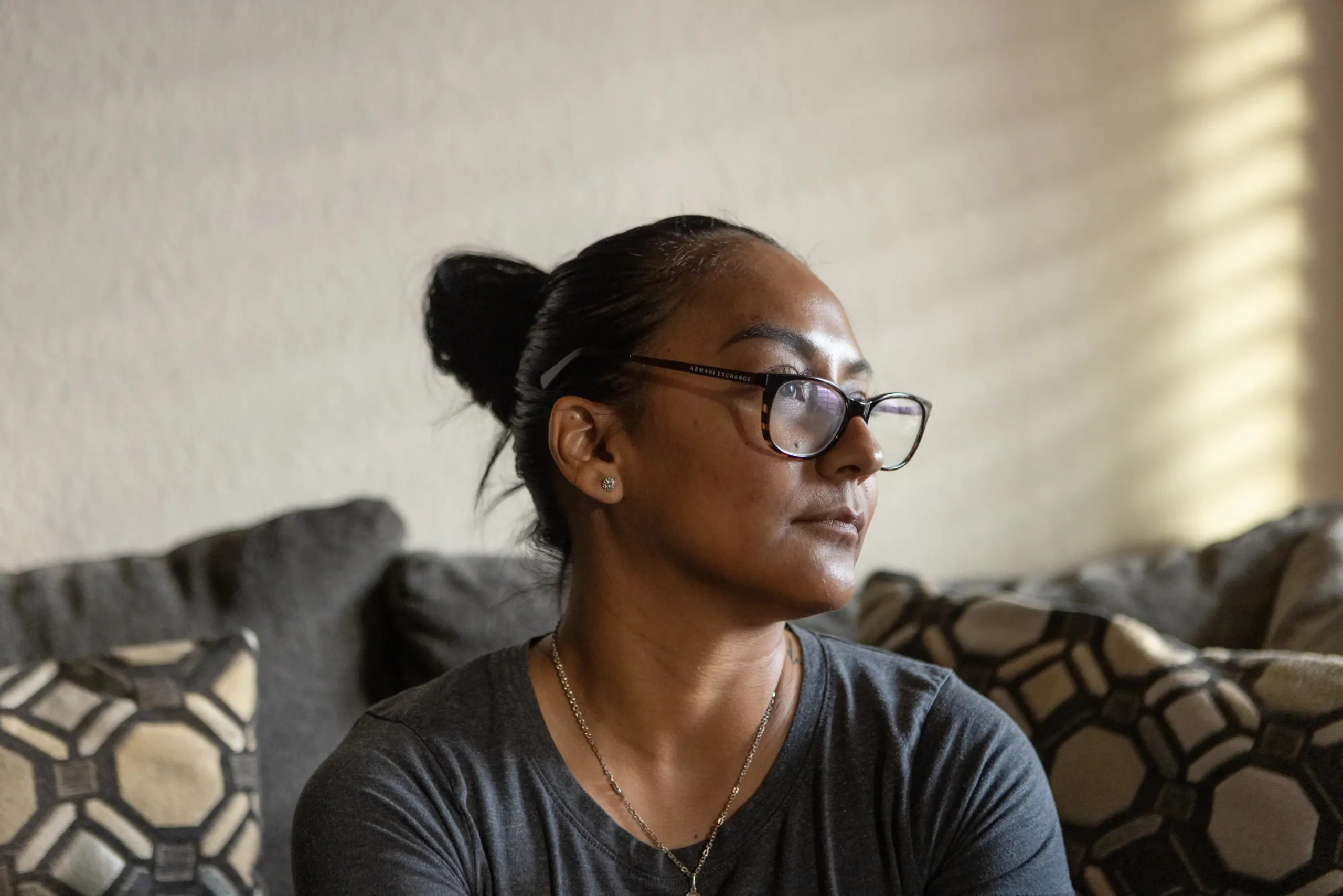 ©Emily Kinskey/The Texas Tribune: Elizabeth Ramirez, mother to three children, sits at home in El Paso. After her eldest child experienced a mental health crisis, Ramirez navigated through the confusing and under-resourced Texas mental health system in search for professional help.