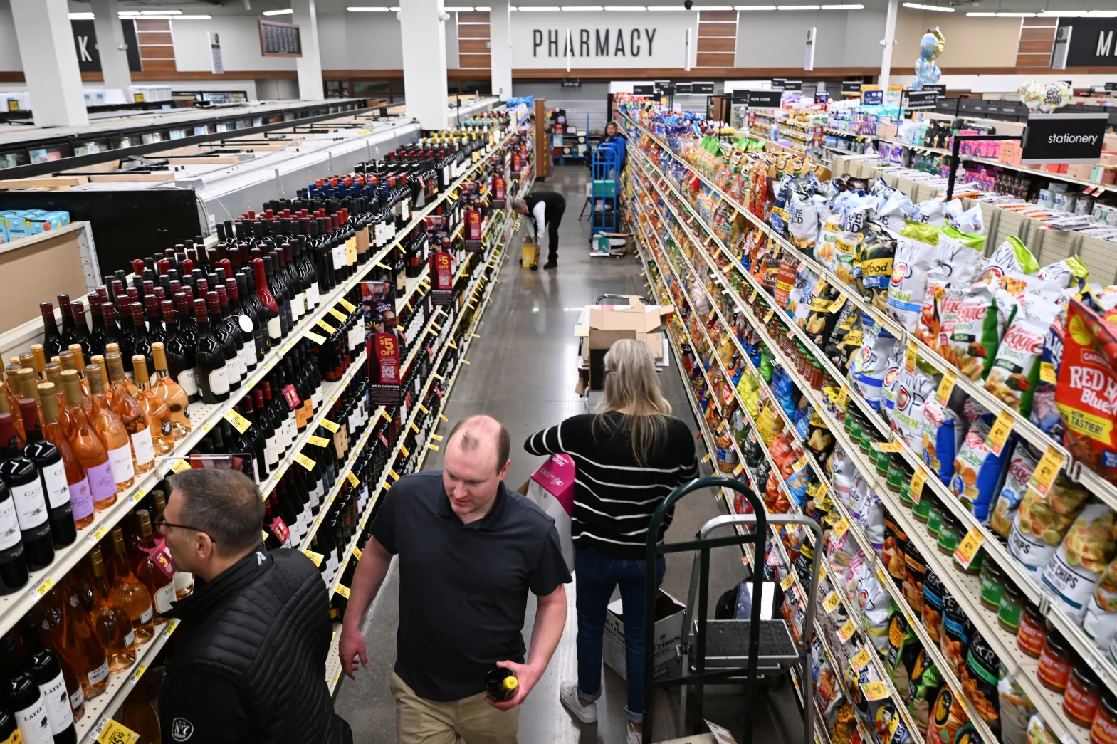 ©RJ Sangosti/The Denver Post: Distributors and suppliers stock wine at a Safeway store in Aurora on March 1, 2023. Colorado voters approved Proposition 125 in 2022, expanding wine sales to grocery stores across the state. 