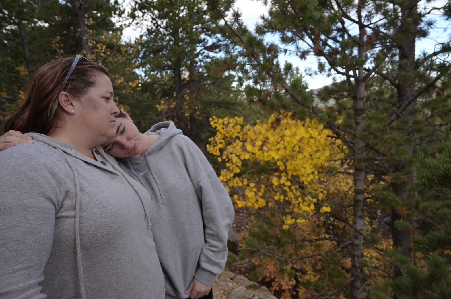 ©Hyoung Chang/The Denver Post: Andrea Carter, left, and her daughter Ashley, 14, comfort each other at Golden Gate Canyon State Park near Black Hawk on Saturday, Sept. 30, 2023. The family spread the ashes of Matt Carter — Andrea’s husband and Ashley’s father — near the site. He died of liver failure at age 39 in 2018 after battling alcohol addiction.