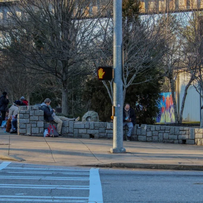 Photo/Ethan Wright: A group of people stand in line at Bigger Vision of Athens in search of a meal and a place to sleep on Wednesday, Feb. 7, 2024.