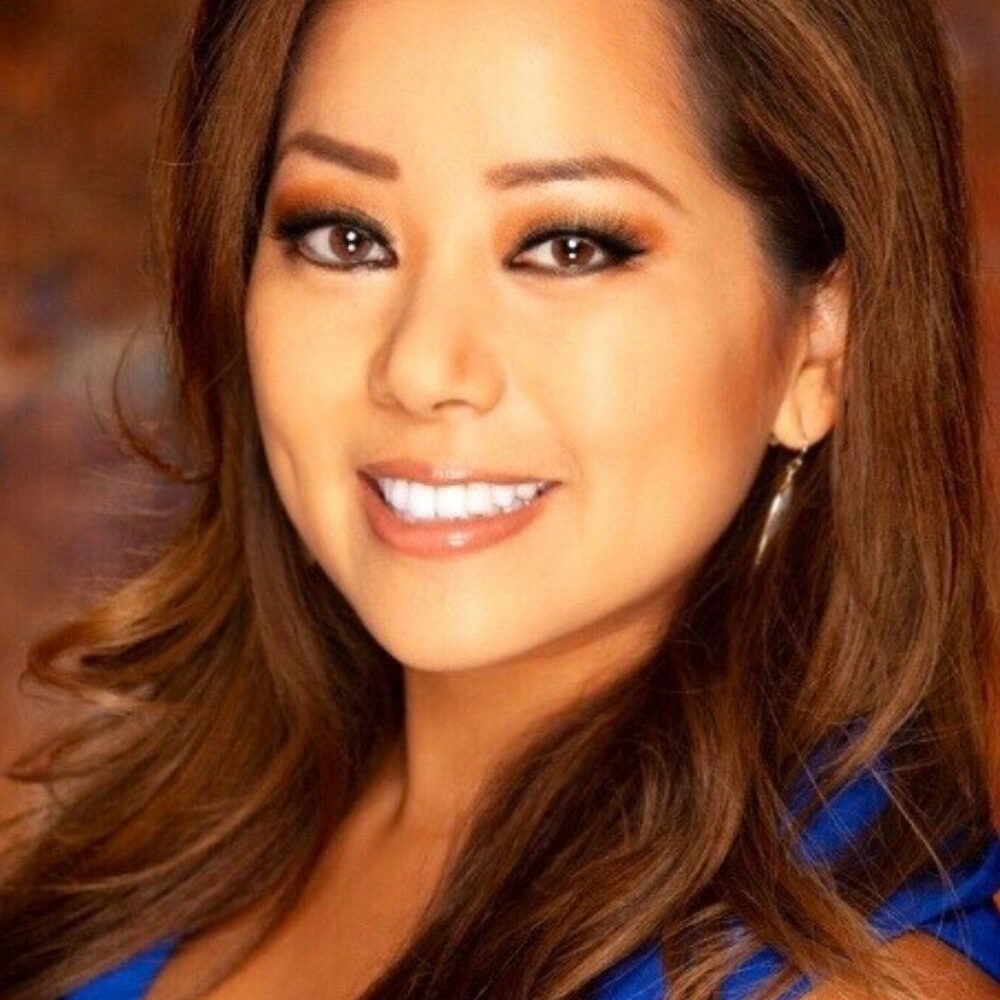 Image of Angela Chen in blue blouse with long, brown hair and eyes.