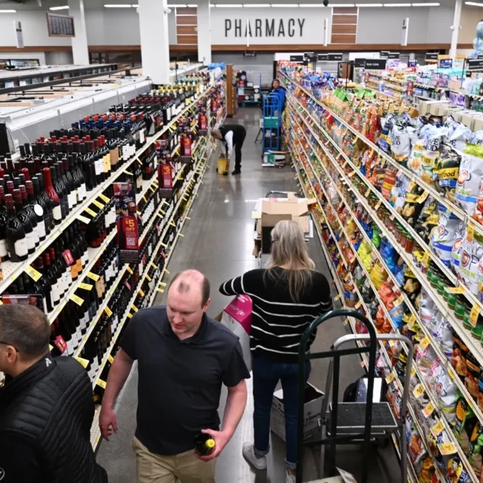 ©RJ Sangosti/The Denver Post: Distributors and suppliers stock wine at a Safeway store in Aurora on March 1, 2023. Colorado voters approved Proposition 125 in 2022, expanding wine sales to grocery stores across the state. 