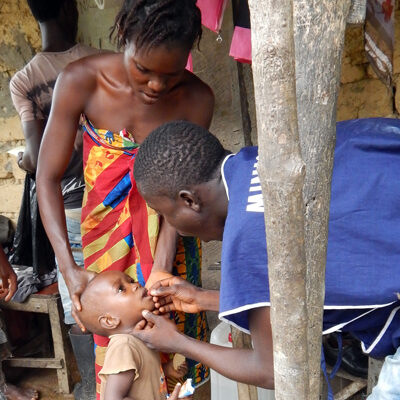 A young girl gets vitamin A supplement during a measles and polio vaccination drive. (Photo/CDC)