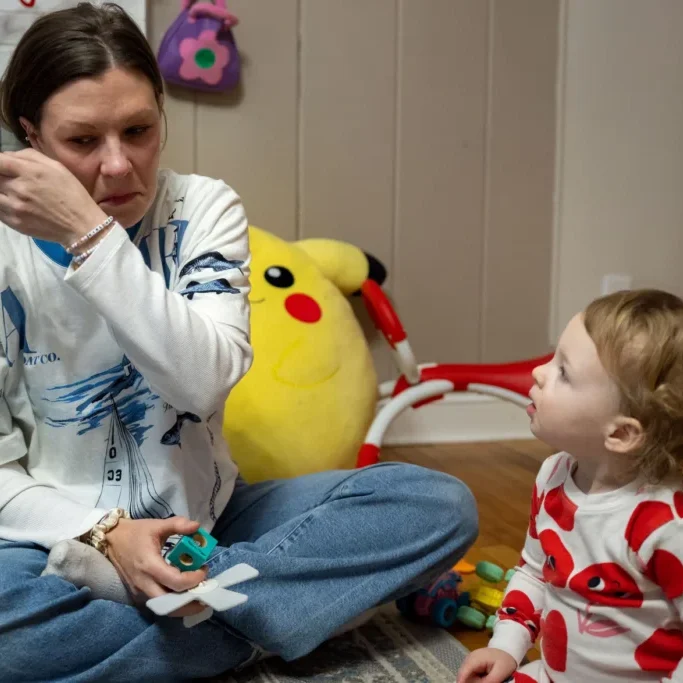 ©Tyler Russell/Connecticut Public: Emily Fields tears up as she reflects on the way postpartum depression initially kept her from connecting with her daughter Emma. 
