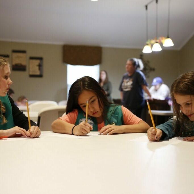 McKinley Reid, Audrianna Guerrero and Sydney Judge are all part of Girl Scout Troop 5596. They started working on activities for their Okay to Say mental health badge in April. "We were learning about stress and empathy and gratitude," Judge explained. ©Trevon McWilliams/KERA